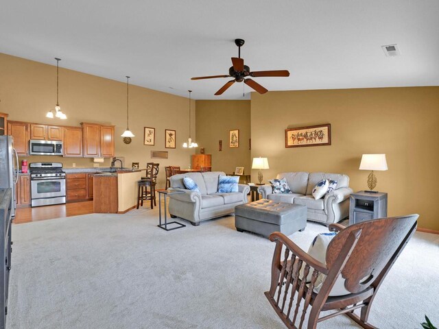 1734 Parkstone Ter Unit 73, Mount Pleasant, WI 53406 - living area featuring light carpet, high vaulted ceiling, visible vents, and ceiling fan