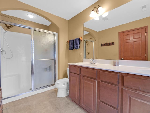 1734 Parkstone Ter Unit 73, Mount Pleasant, WI 53406 - bathroom featuring a shower stall, visible vents, toilet, a sink, and double vanity