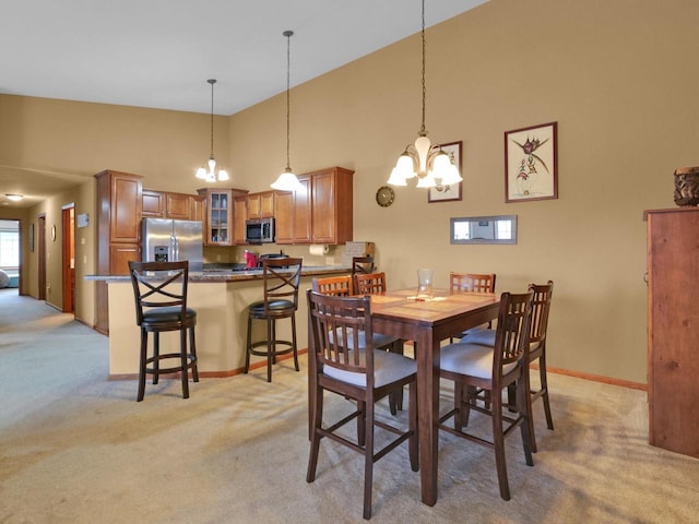 1734 Parkstone Ter Unit 73, Mount Pleasant, WI 53406 - dining room with a chandelier, light carpet, and high vaulted ceiling