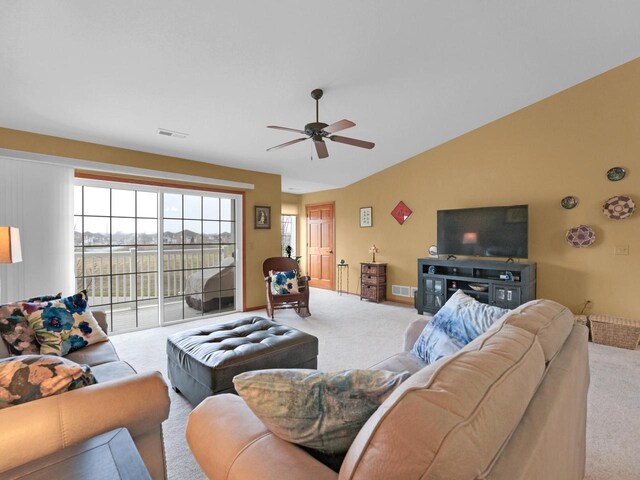 1734 Parkstone Ter Unit 73, Mount Pleasant, WI 53406 - living area with visible vents, ceiling fan, vaulted ceiling, and carpet floors