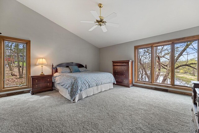 carpeted bedroom featuring ceiling fan and lofted ceiling