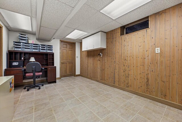 office area featuring wooden walls and baseboards