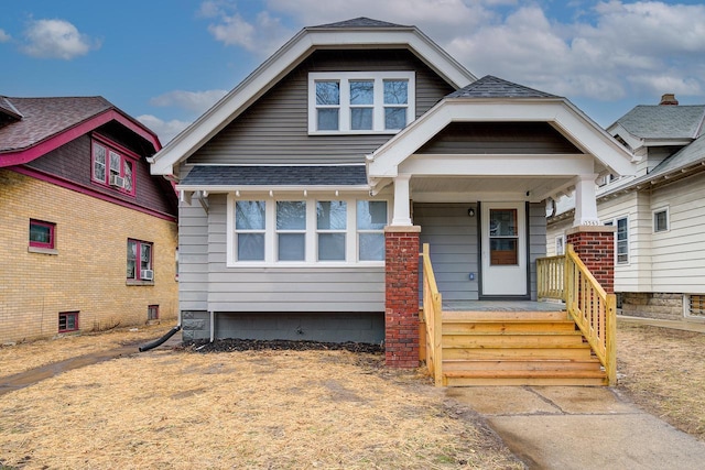 view of front of property featuring a porch and roof with shingles