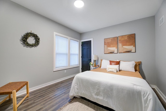bedroom featuring baseboards and dark wood finished floors