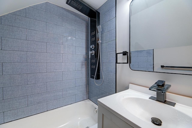 bathroom featuring washtub / shower combination and vanity