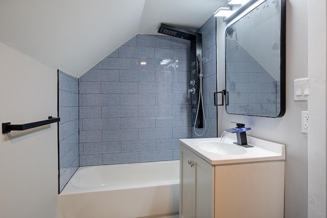 bathroom featuring washtub / shower combination, vanity, and vaulted ceiling