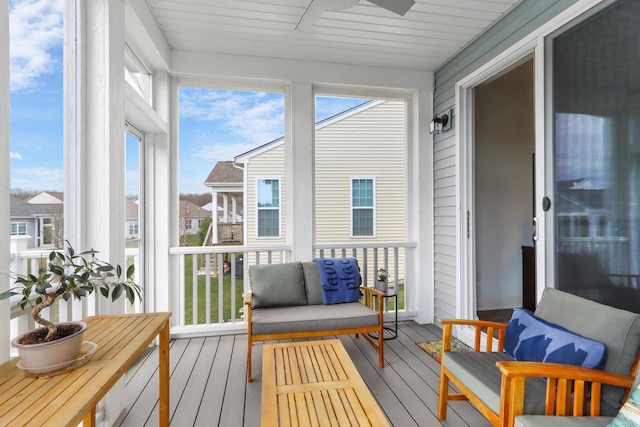 sunroom / solarium featuring ceiling fan