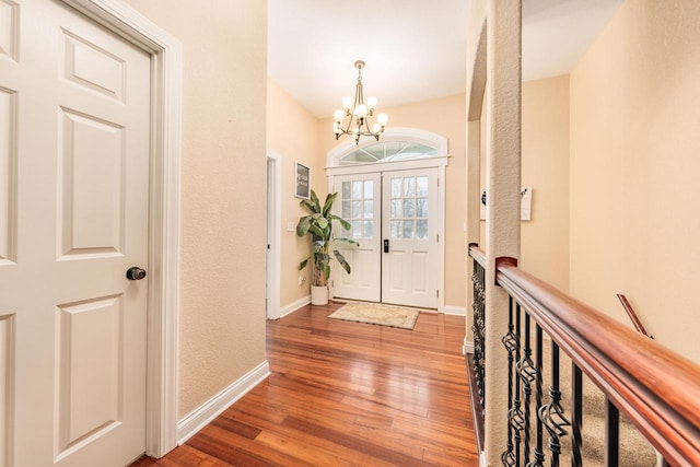 W209N11385 Reger Ct, Germantown, WI 53022 - entrance foyer featuring wood finished floors, an inviting chandelier, and baseboards