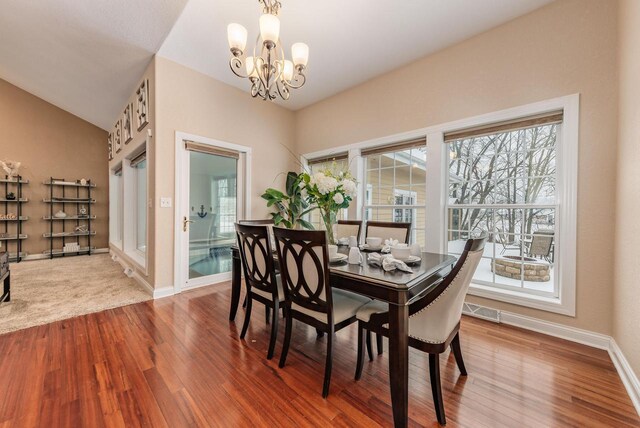 W209N11385 Reger Ct, Germantown, WI 53022 - dining space featuring wood finished floors, an inviting chandelier, visible vents, and a wealth of natural light