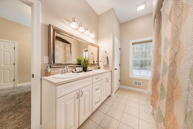 W209N11385 Reger Ct, Germantown, WI 53022 - full bath with a sink, visible vents, baseboards, and double vanity