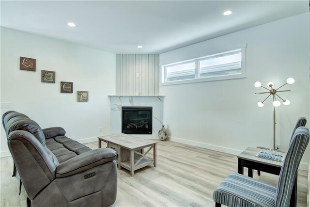 2480 116th St, Chippewa Falls, WI 54729 - living area with a premium fireplace, recessed lighting, baseboards, and light wood-style flooring