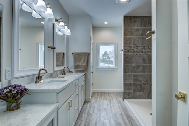 2480 116th St, Chippewa Falls, WI 54729 - full bath with a sink, baseboards, tiled shower, and double vanity