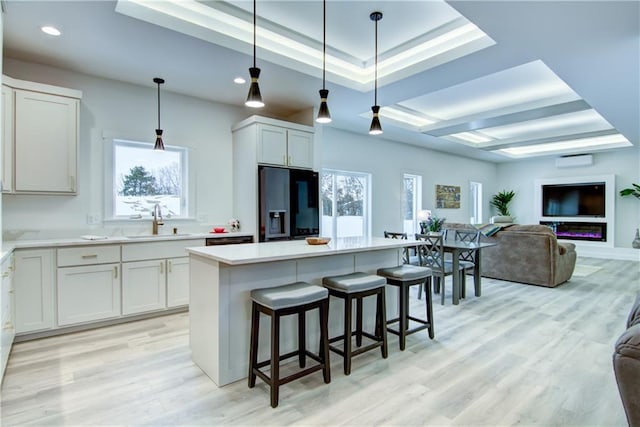 2480 116th St, Chippewa Falls, WI 54729 - kitchen with a raised ceiling, open floor plan, black refrigerator with ice dispenser, a healthy amount of sunlight, and a sink