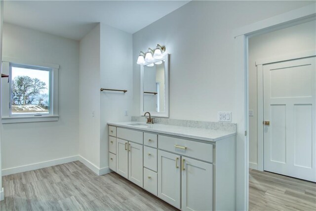 2480 116th St, Chippewa Falls, WI 54729 - bathroom featuring vanity, baseboards, and wood finished floors