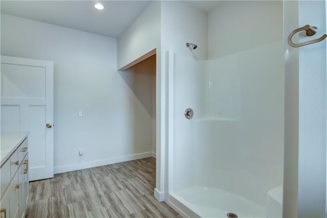 2480 116th St, Chippewa Falls, WI 54729 - bathroom featuring vanity, baseboards, a stall shower, recessed lighting, and wood finished floors