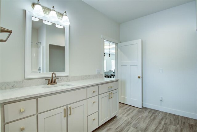 2480 116th St, Chippewa Falls, WI 54729 - full bathroom with baseboards, a shower, vanity, and wood finished floors