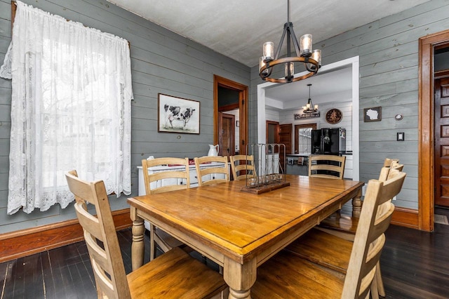 158 E Water St, Shullsburg, WI 53586 - dining area featuring an inviting chandelier, wood-type flooring, and wooden walls