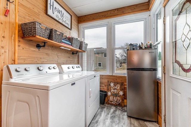 158 E Water St, Shullsburg, WI 53586 - laundry room with wood walls, light wood finished floors, separate washer and dryer, and laundry area
