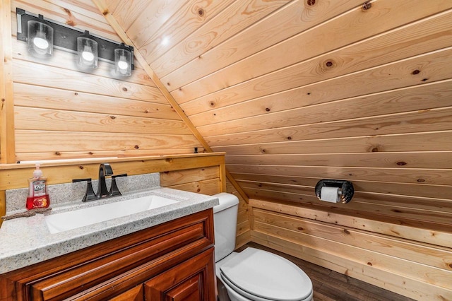 158 E Water St, Shullsburg, WI 53586 - bathroom with vanity, toilet, wooden ceiling, lofted ceiling, and wooden walls
