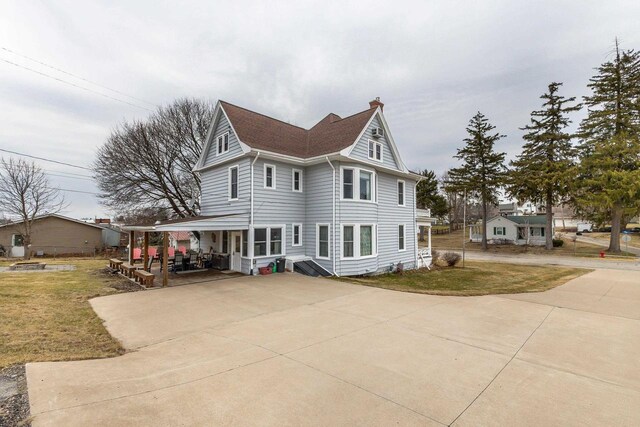 158 E Water St, Shullsburg, WI 53586 - exterior space with a chimney, concrete driveway, and a lawn