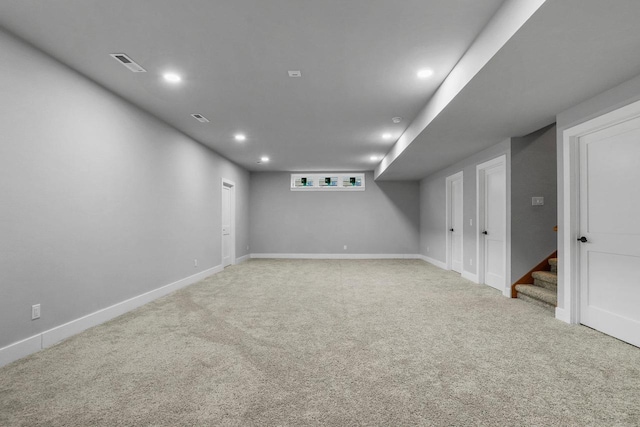 3102 Hope St, Sun Prairie, WI 53590 - finished below grade area with stairway, visible vents, light colored carpet, and baseboards