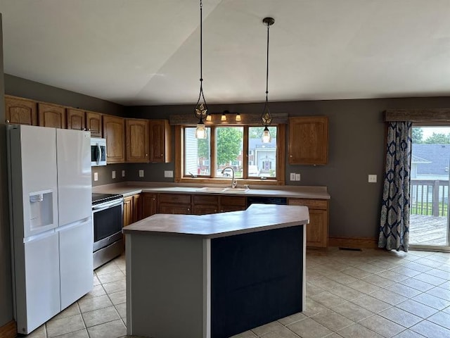 229 N Monroe St, Lancaster, WI 53813 - kitchen with light tile patterned floors, light countertops, a sink, stainless steel appliances, and brown cabinets