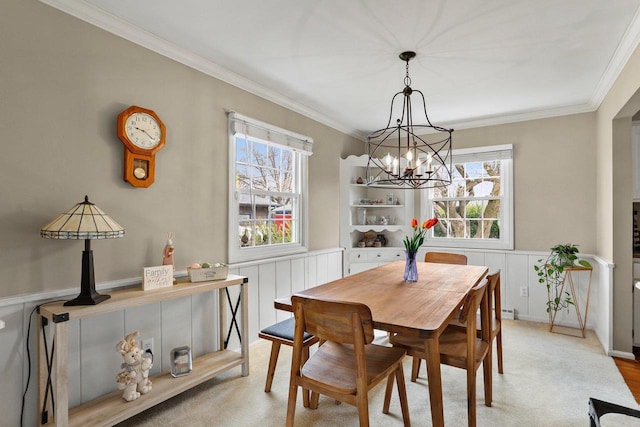 dining room with crown molding, a notable chandelier, and a healthy amount of sunlight