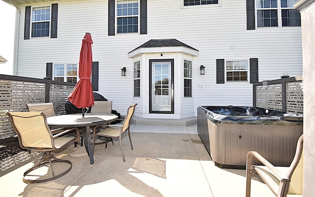 view of patio / terrace with a hot tub and outdoor dining area
