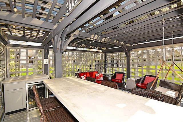 view of patio / terrace featuring beverage cooler, a pergola, outdoor dining area, and outdoor lounge area