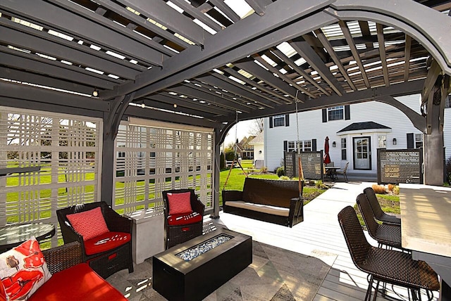 wooden terrace with a pergola, a patio, and an outdoor living space with a fire pit