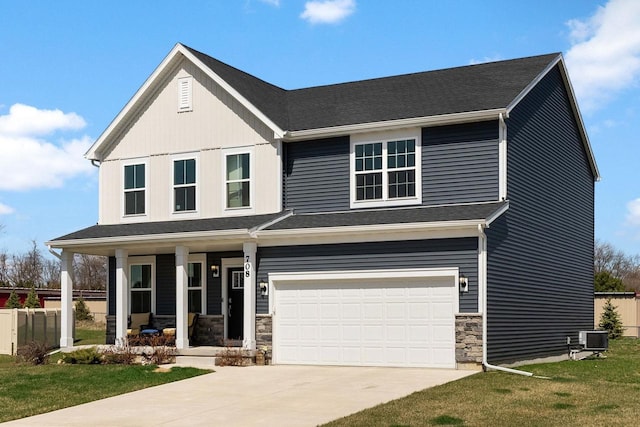 708 Narvik Cir, Stoughton, WI 53589 - view of front of home featuring central AC, a porch, stone siding, an attached garage, and concrete driveway