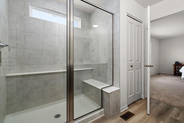 708 Narvik Cir, Stoughton, WI 53589 - full bath featuring a shower stall, wood finished floors, and visible vents