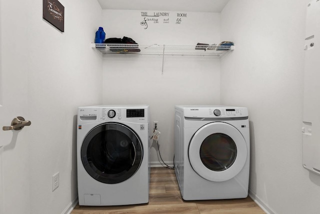 708 Narvik Cir, Stoughton, WI 53589 - laundry area with baseboards, light wood-style floors, washer and dryer, and laundry area