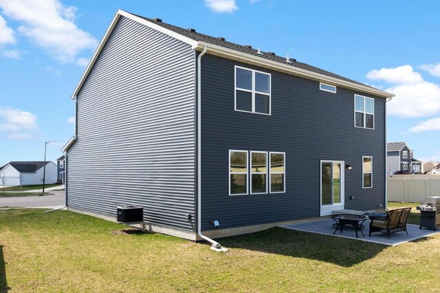 708 Narvik Cir, Stoughton, WI 53589 - back of house featuring cooling unit, a patio area, fence, and a lawn