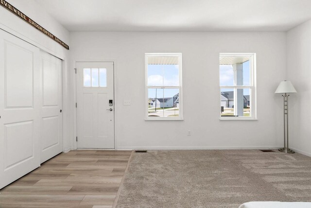 708 Narvik Cir, Stoughton, WI 53589 - entrance foyer featuring light wood-type flooring, baseboards, and visible vents