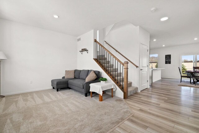 708 Narvik Cir, Stoughton, WI 53589 - living area with light wood-style floors, baseboards, stairway, and recessed lighting