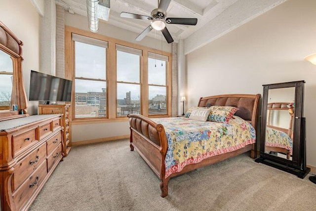 bedroom featuring carpet flooring, multiple windows, and baseboards
