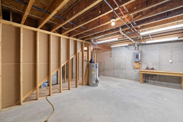 unfinished basement with gas water heater and electric panel