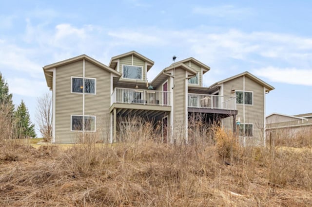 rear view of property featuring a deck