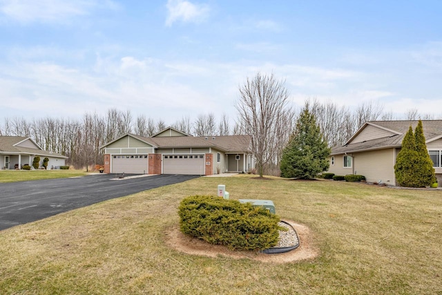 view of front facade featuring brick siding, a front yard, a garage, and driveway
