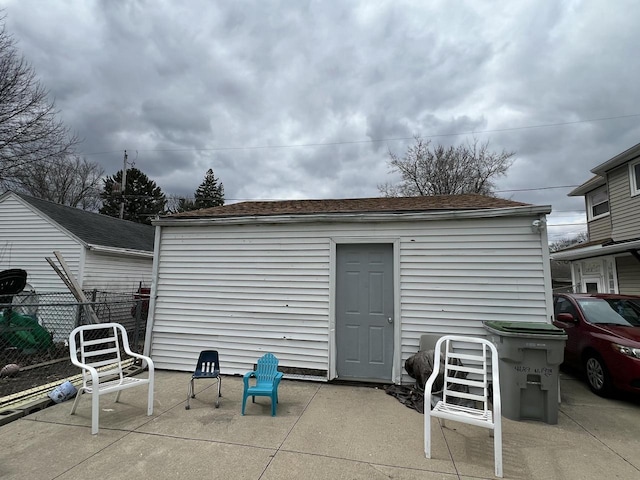 view of patio featuring fence and an outdoor structure