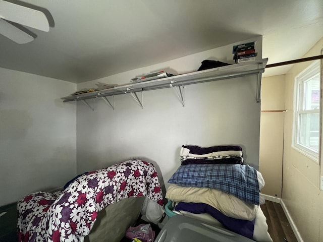 bedroom featuring ceiling fan, baseboards, and wood finished floors
