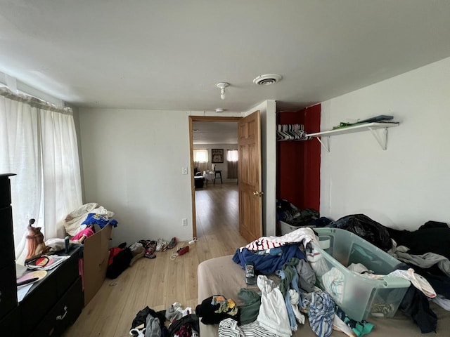 bedroom with visible vents and light wood-style flooring