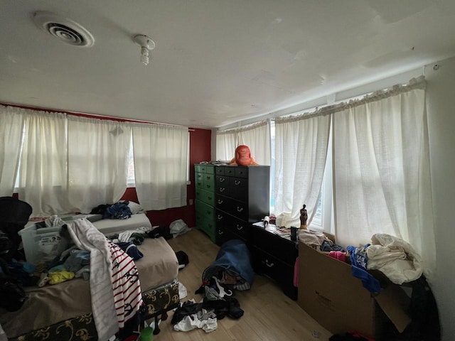 bedroom featuring visible vents and wood finished floors