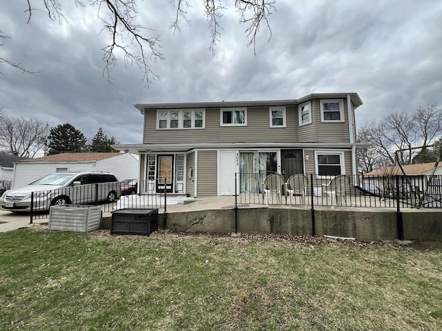 rear view of property featuring a lawn