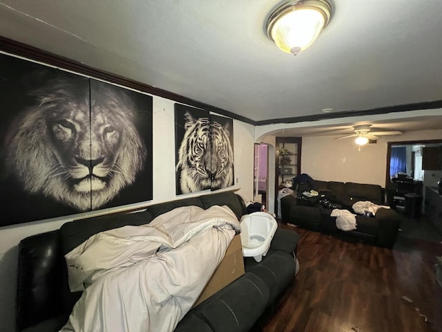 bedroom featuring arched walkways and wood finished floors
