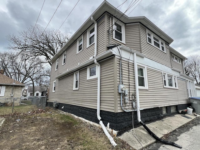 view of home's exterior with fence