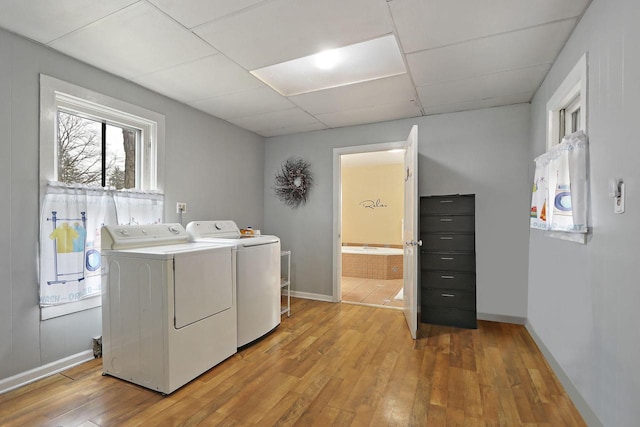 8207 12th St, Kenosha, WI 53144 - washroom featuring independent washer and dryer, light wood finished floors, laundry area, and baseboards