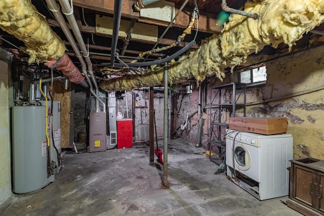 basement featuring water heater, washer / clothes dryer, and heating unit