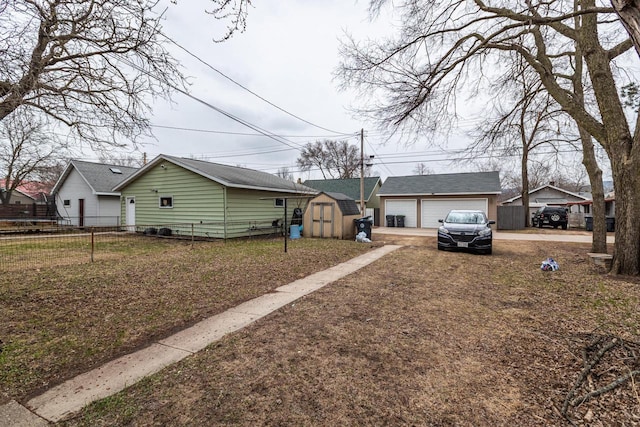 view of front of property with a shed, an outbuilding, a garage, and fence